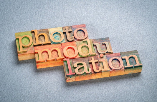 artistic representation of the word “photomodulation” in colored wooden blocks